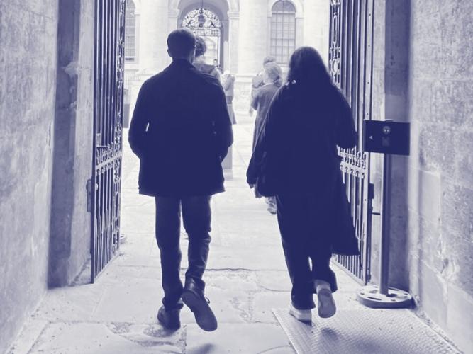 Two young people walking through an Oxford college gate into a courtyard, overlaid with purple Astrophoria Foundation Year graphics.