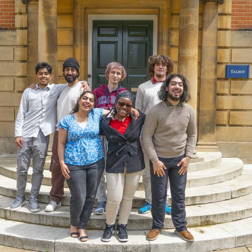 A group of students from the first cohort of the Astrophoria Foundation Year standing on steps outside Talbot Hall at Lady Margaret Hall college