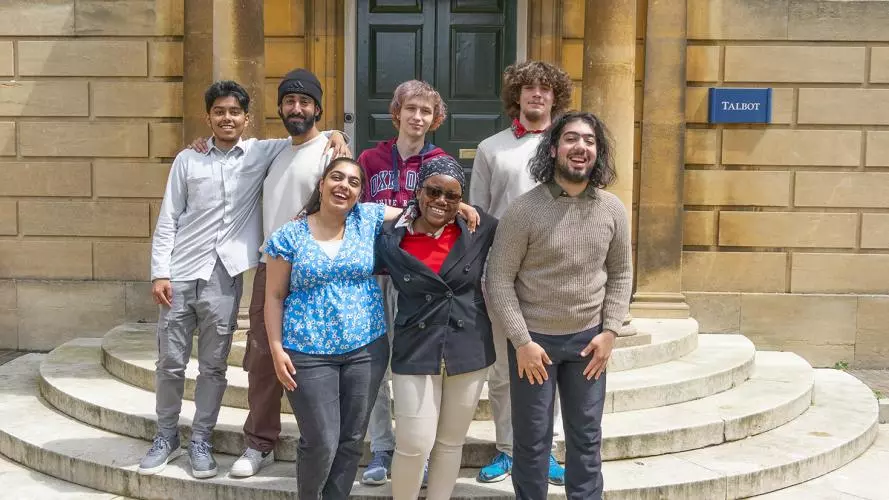 A group of students from the first cohort of the Astrophoria Foundation Year standing on steps outside Talbot Hall at Lady Margaret Hall college
