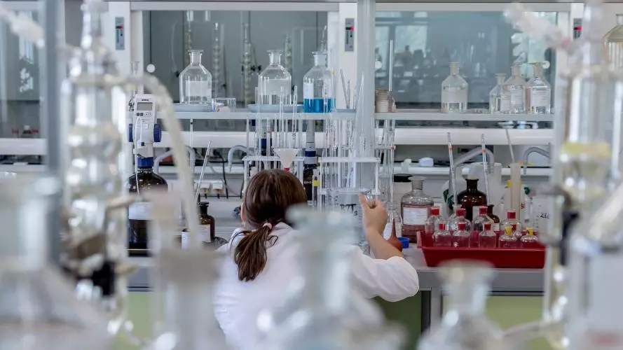 A young woman working in a chemistry lab