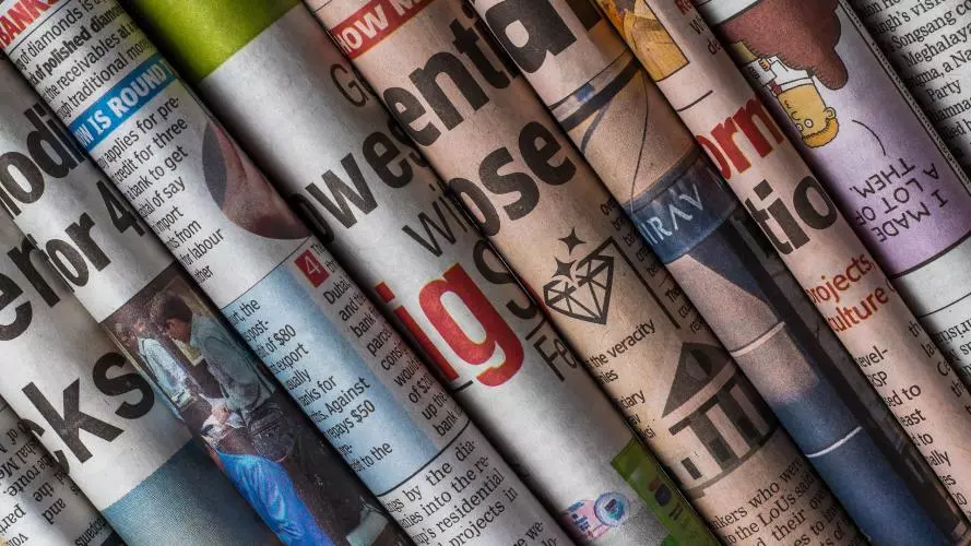 Several newspapers rolled up and grouped together