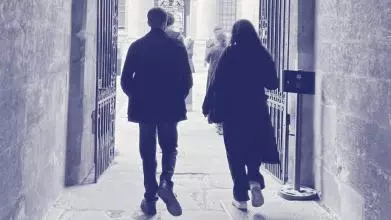 Two young people walking through an Oxford college gate into a courtyard, overlaid with purple Astrophoria Foundation Year graphics.