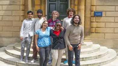 A group of students from the first cohort of the Astrophoria Foundation Year standing on steps outside Talbot Hall at Lady Margaret Hall college