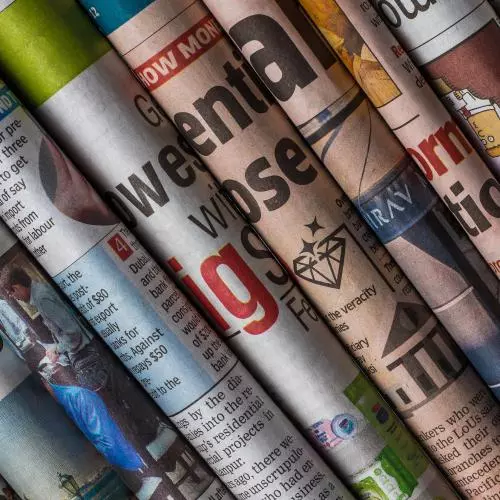 Several newspapers rolled up and grouped together