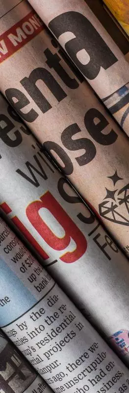 Several newspapers rolled up and grouped together