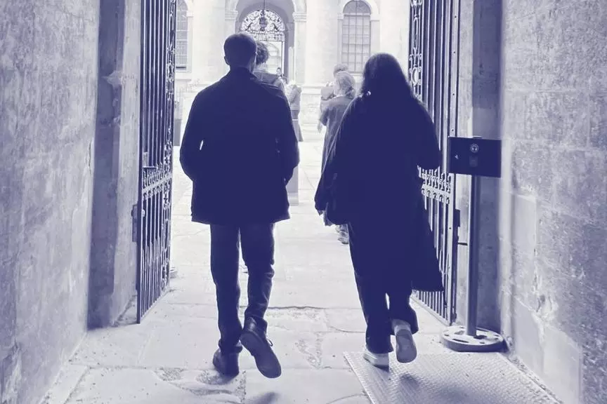 Two young people walking through an Oxford college gate into a courtyard, overlaid with purple Astrophoria Foundation Year graphics.
